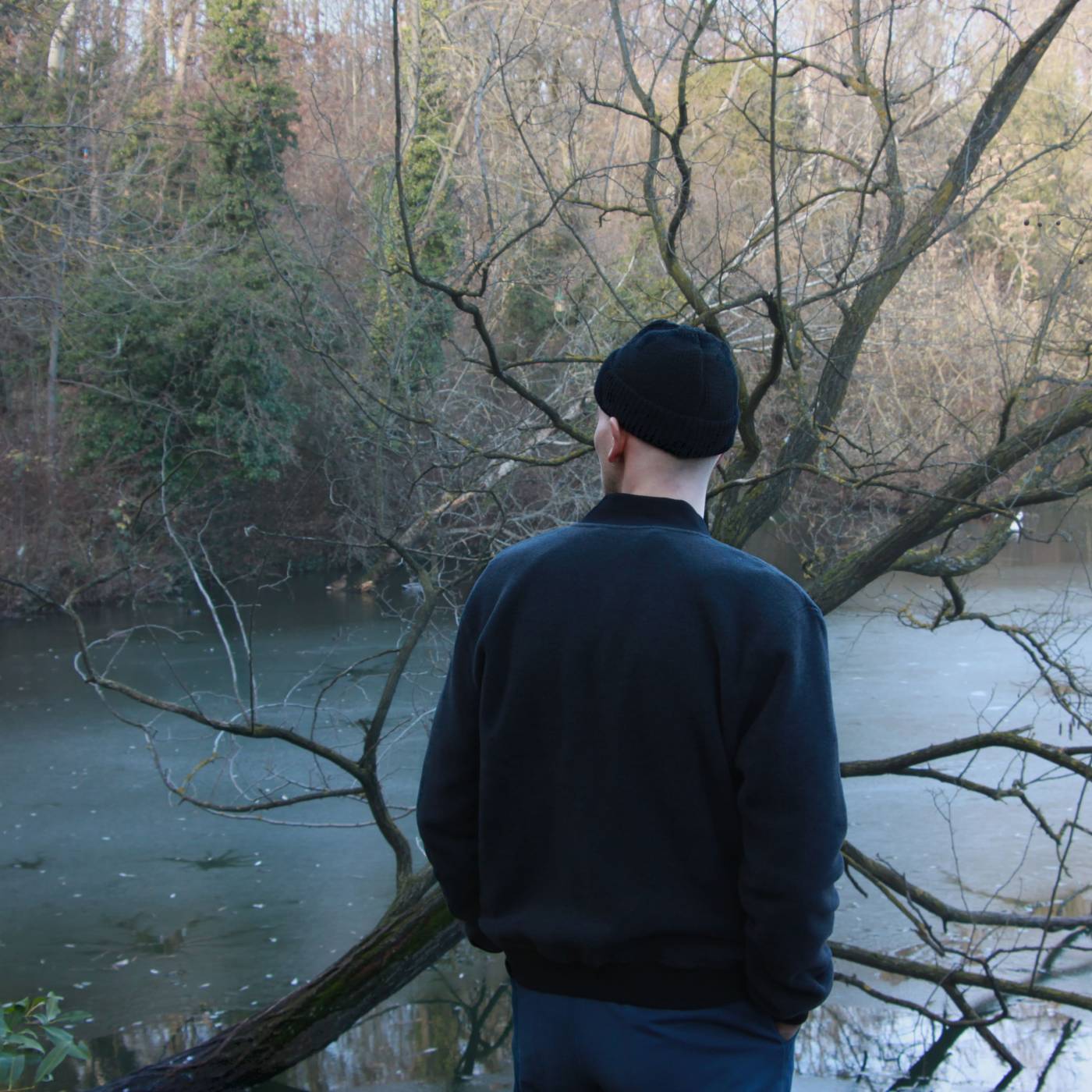a male model wearing a dark grey bomber jacket made from soft merino fleece fabric
