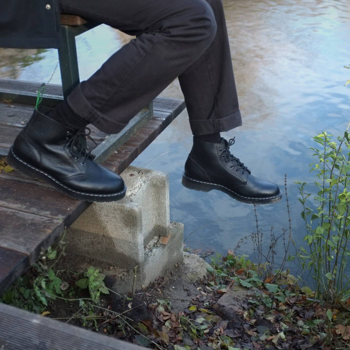 laced ankle high winter boots made from black soft grain leather with classic goodyear welted sole and grey stitching similar to Dr Martens boots